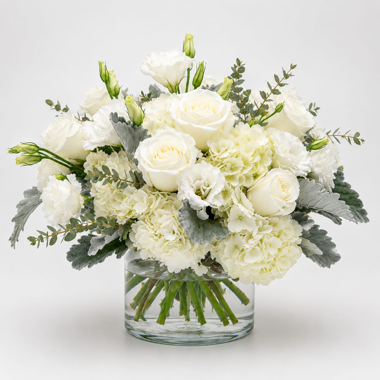 White Cloud - perfect arrangement for a dinner party to make a clean Beautiful Elegant statement with white   fluffy hydrangeas, large and white roses and delicate Lisianthus in a crystal vase. 