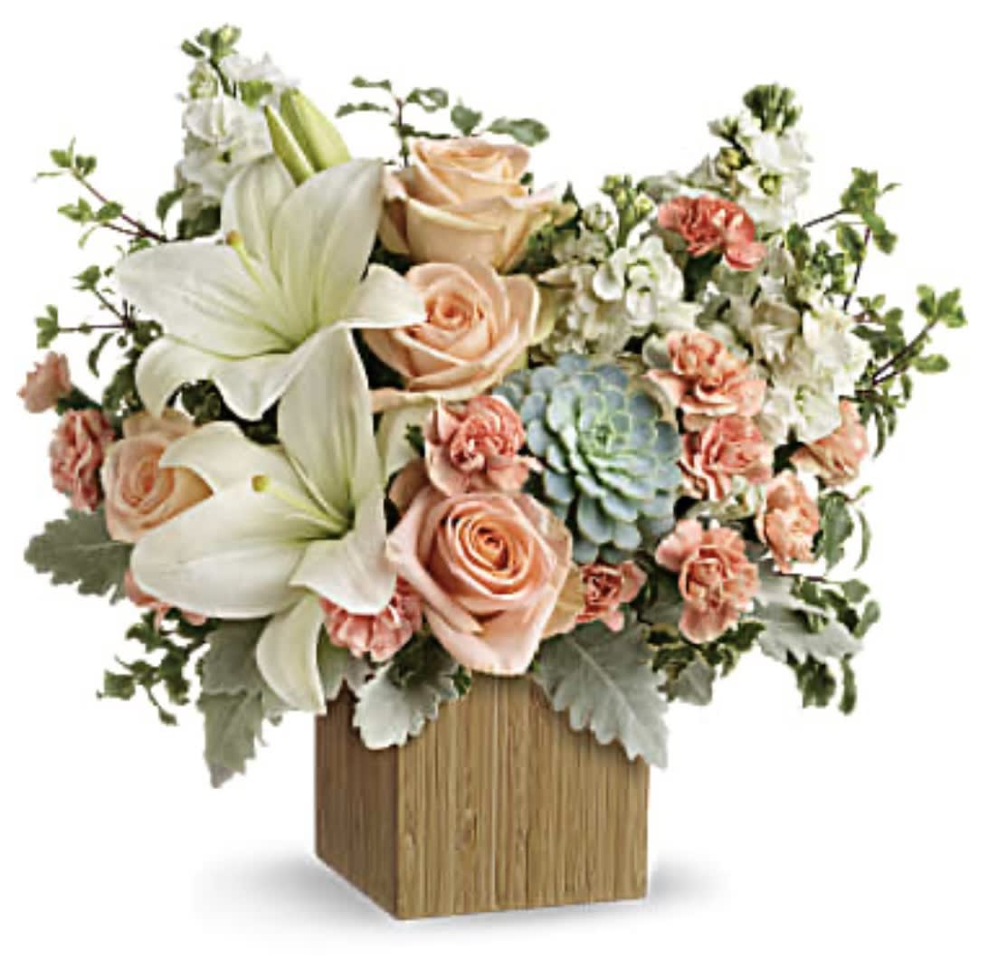 Peach roses and white lilies in a wooden cube vase