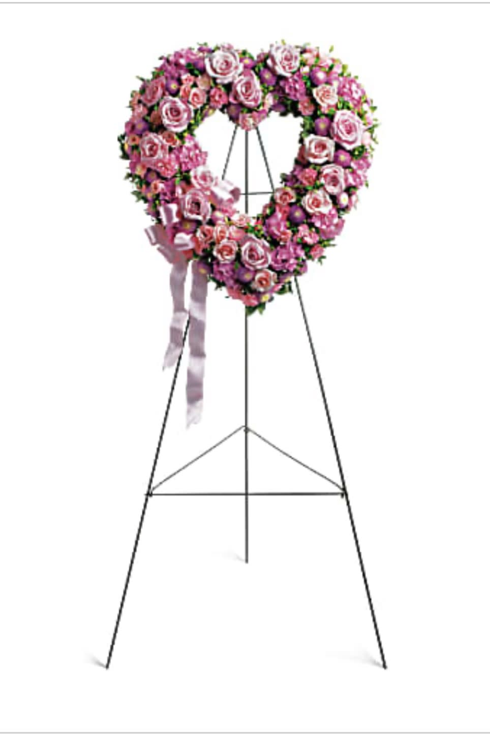 Pink rose funeral wreath on a standing easel with ribbon