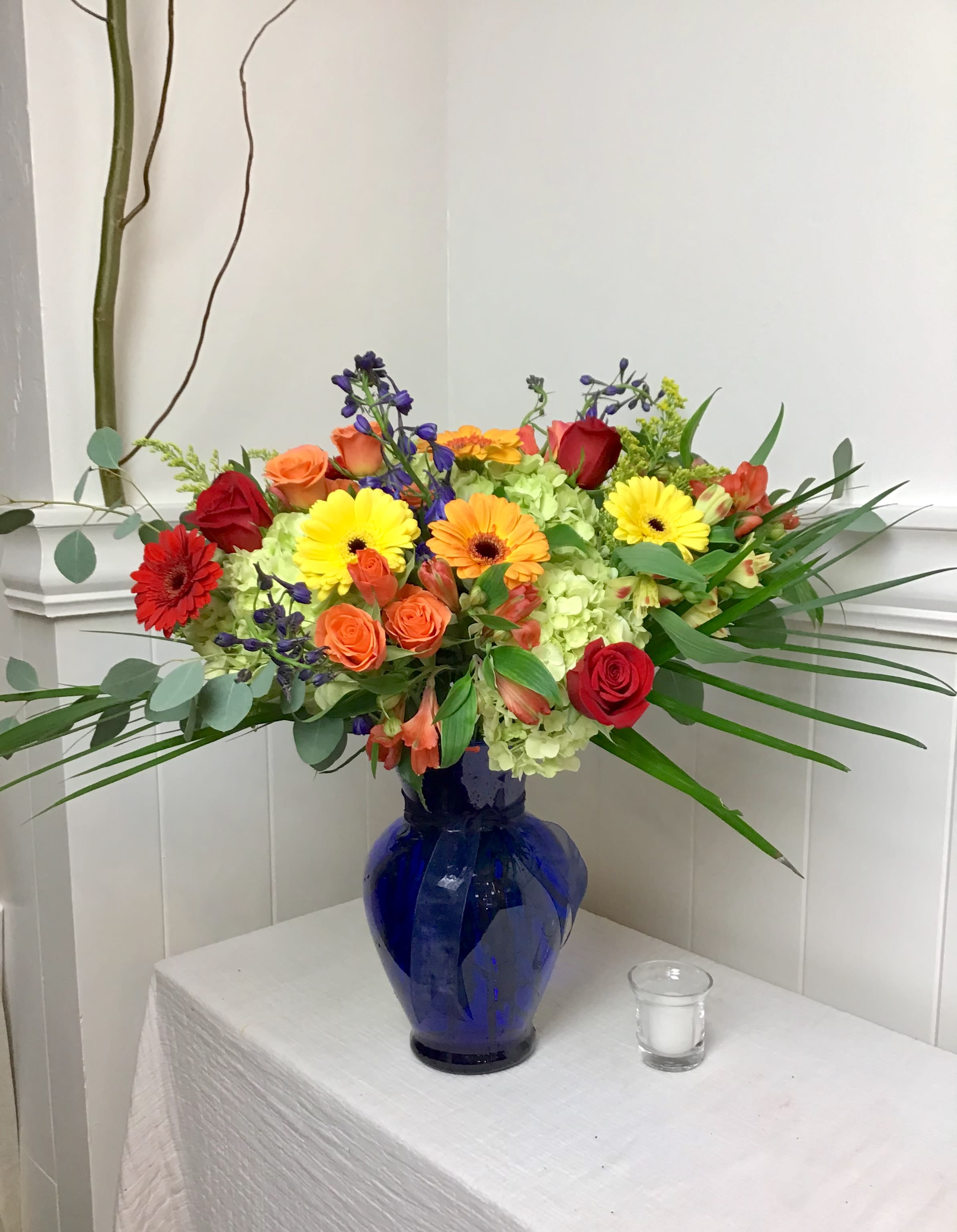 Colorful mixed bouquet in a blue glass vase