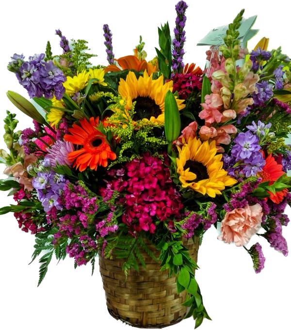 Colorful mixed flower arrangement in a woven basket