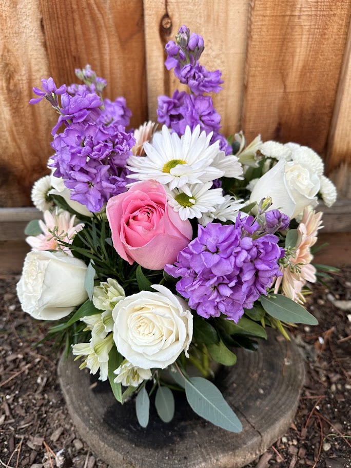 Bouquet of pink and white roses with purple blooms and white daisies