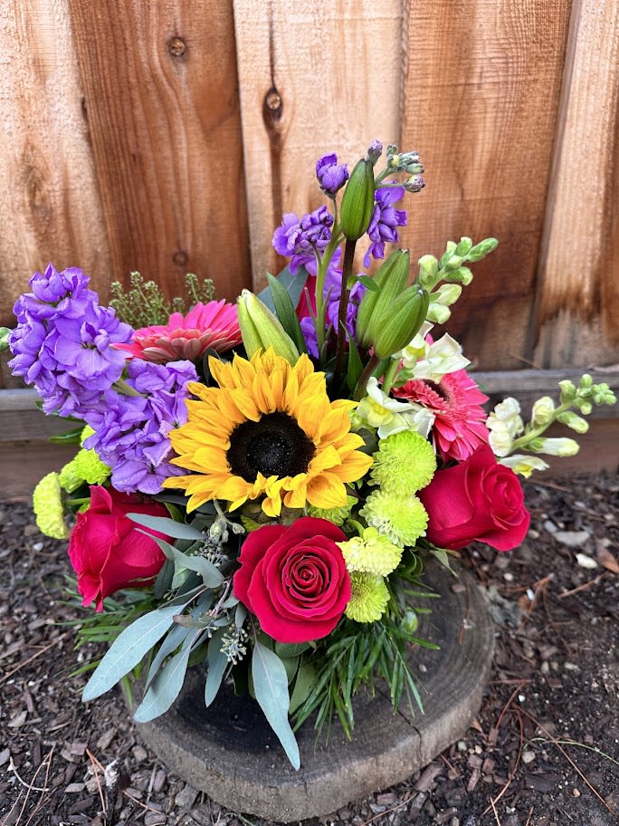 Colorful bouquet with sunflowers, roses, and purple blooms