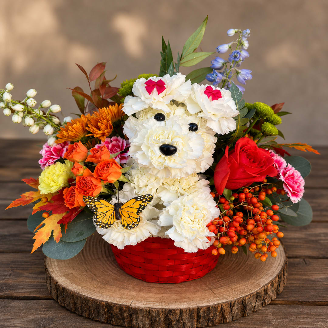 Flower arrangement in a red basket shaped like a bear face with a butterfly accent