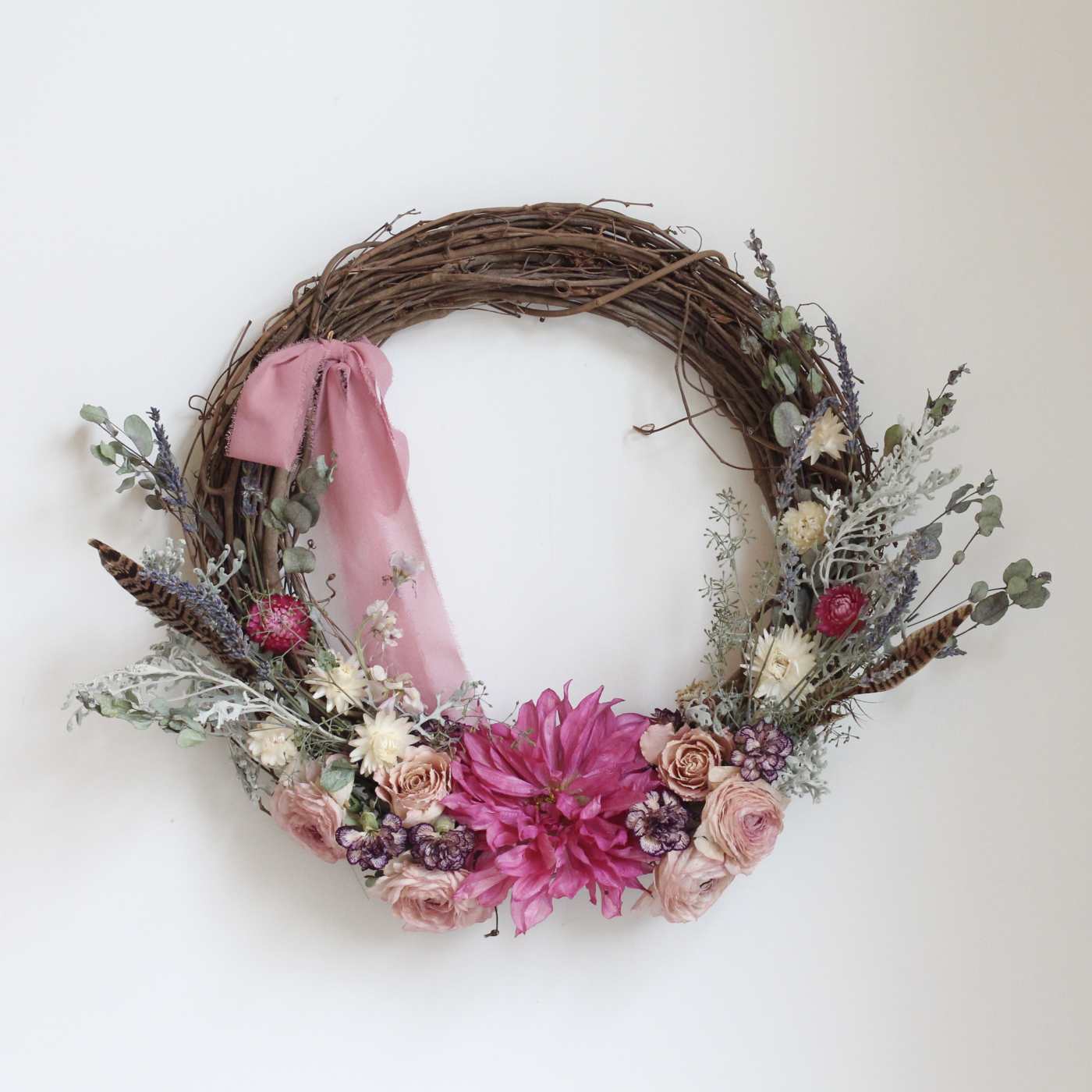 Floral wreath with pink and cream flowers on a grapevine ring