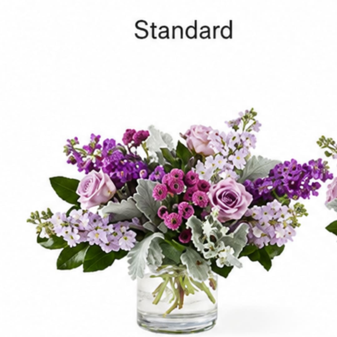 Lavender and pink flower arrangement in a clear glass vase
