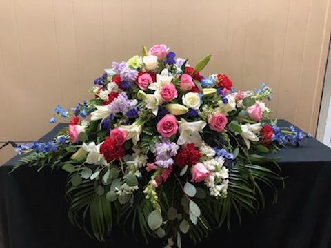 Large mixed floral arrangement with pink, white, red, and blue flowers