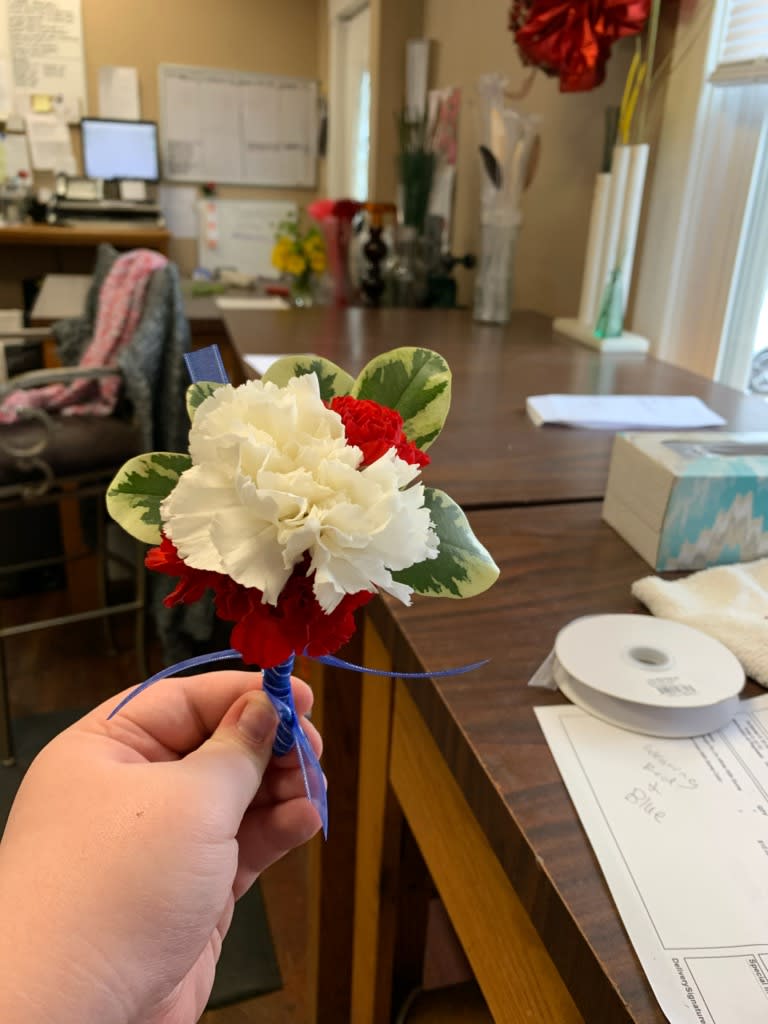 Patriotic Carnations Boutonnière - Red and white carnations, green Pitt and royal blue ribbon, make this a very patriotic show. Colors can be substituted. Please note or call with substitutions. Thank you!
