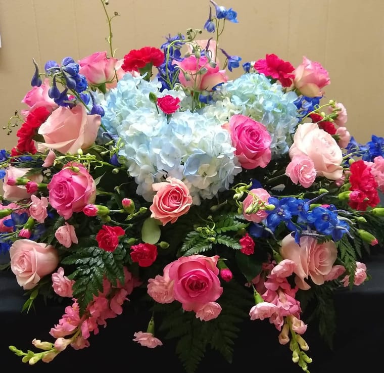 Mixed bouquet with pink roses, blue hydrangeas, and blue flowers