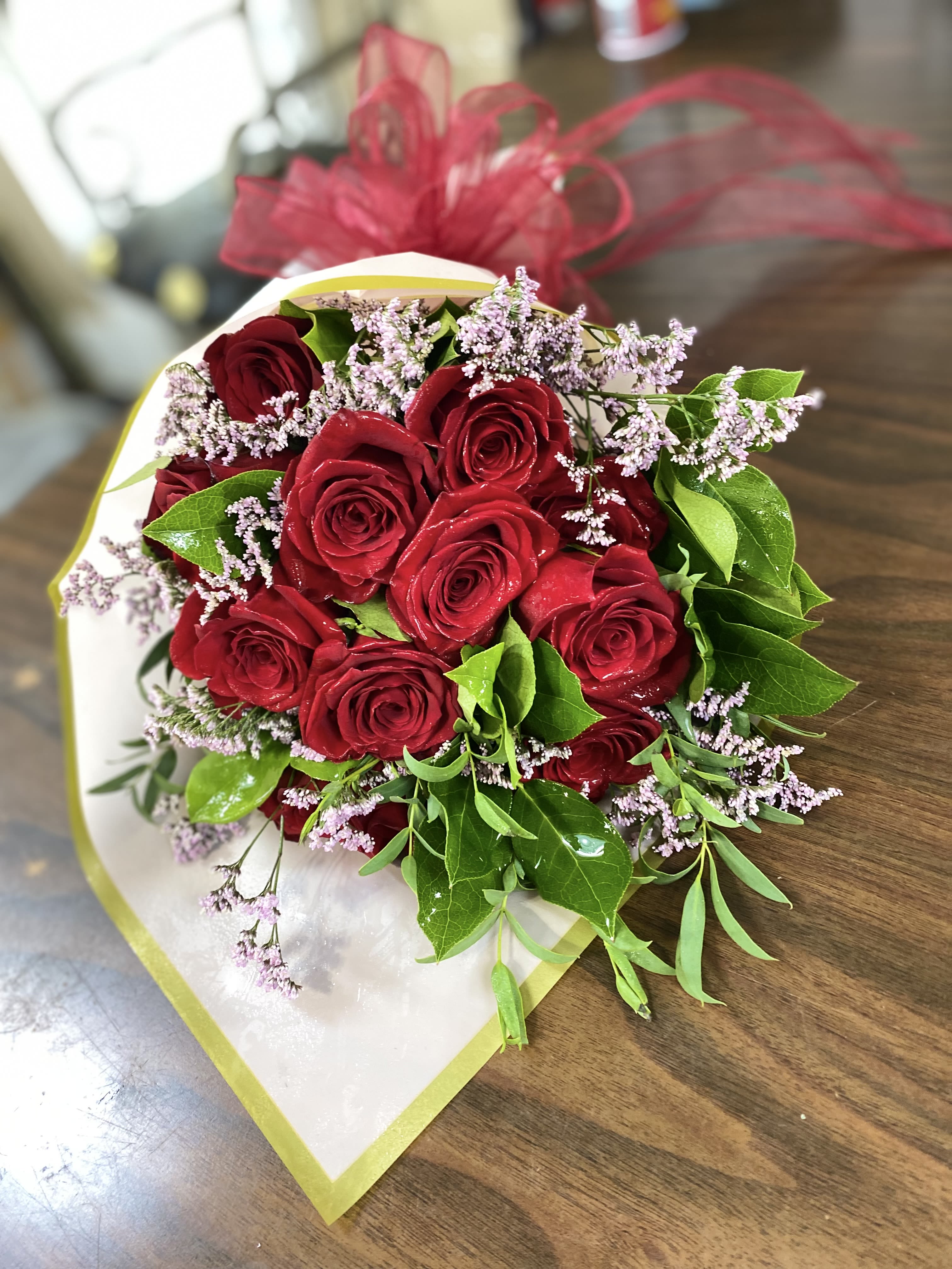 Bouquet of red roses with small lavender filler flowers