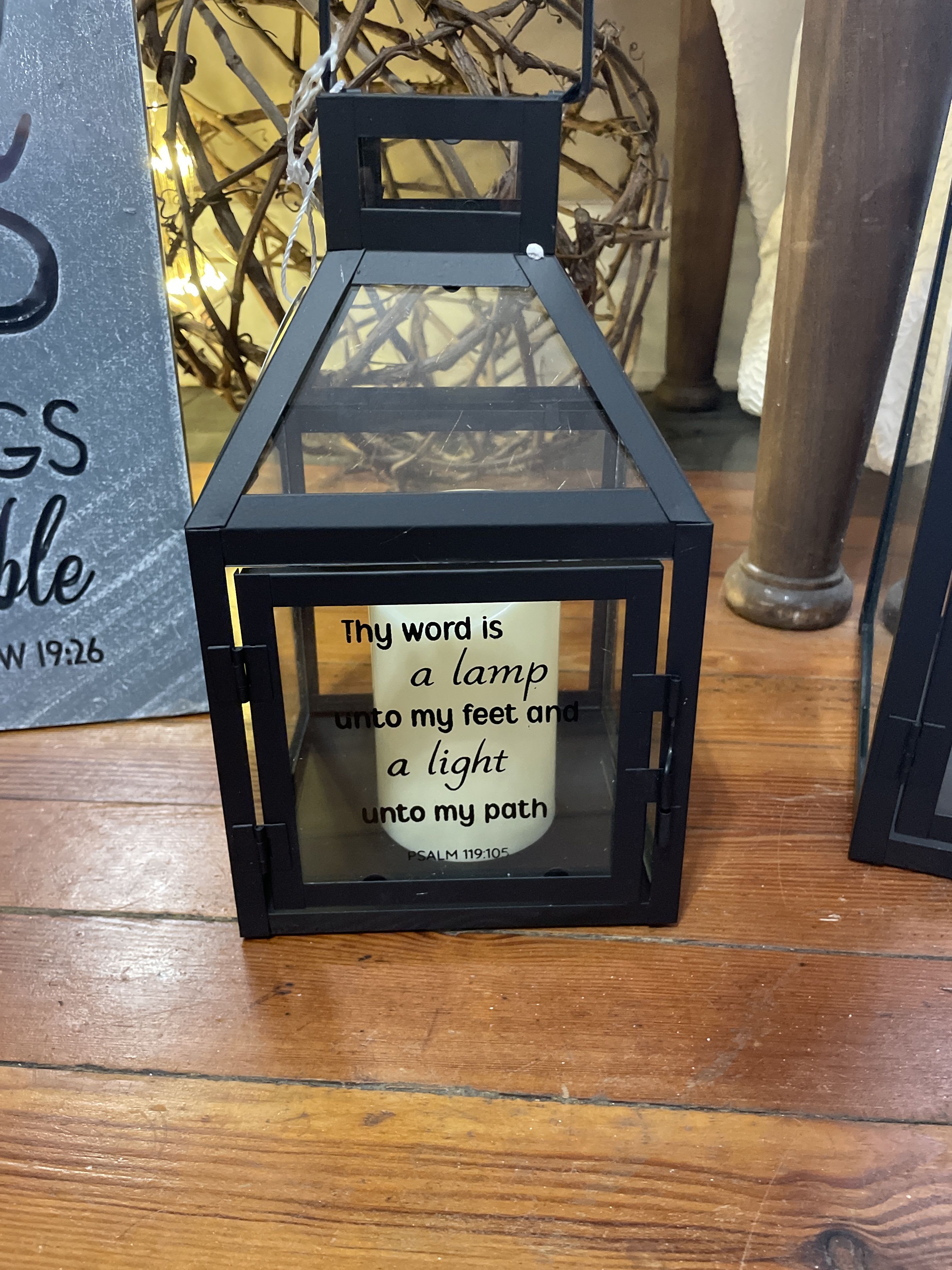 Black lantern with a candle and Bible verse text inside