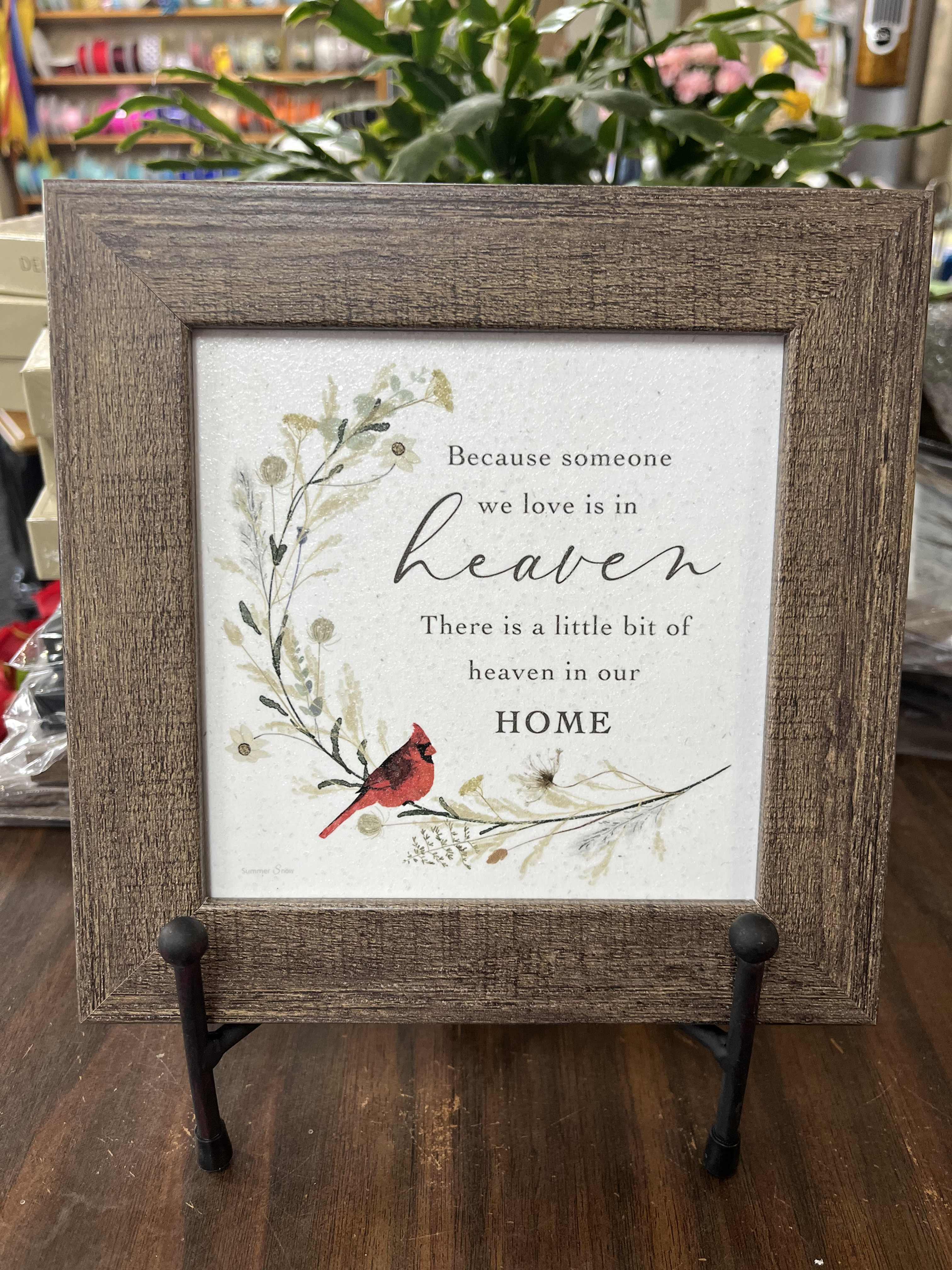 Framed memorial sign with a red cardinal and floral illustration