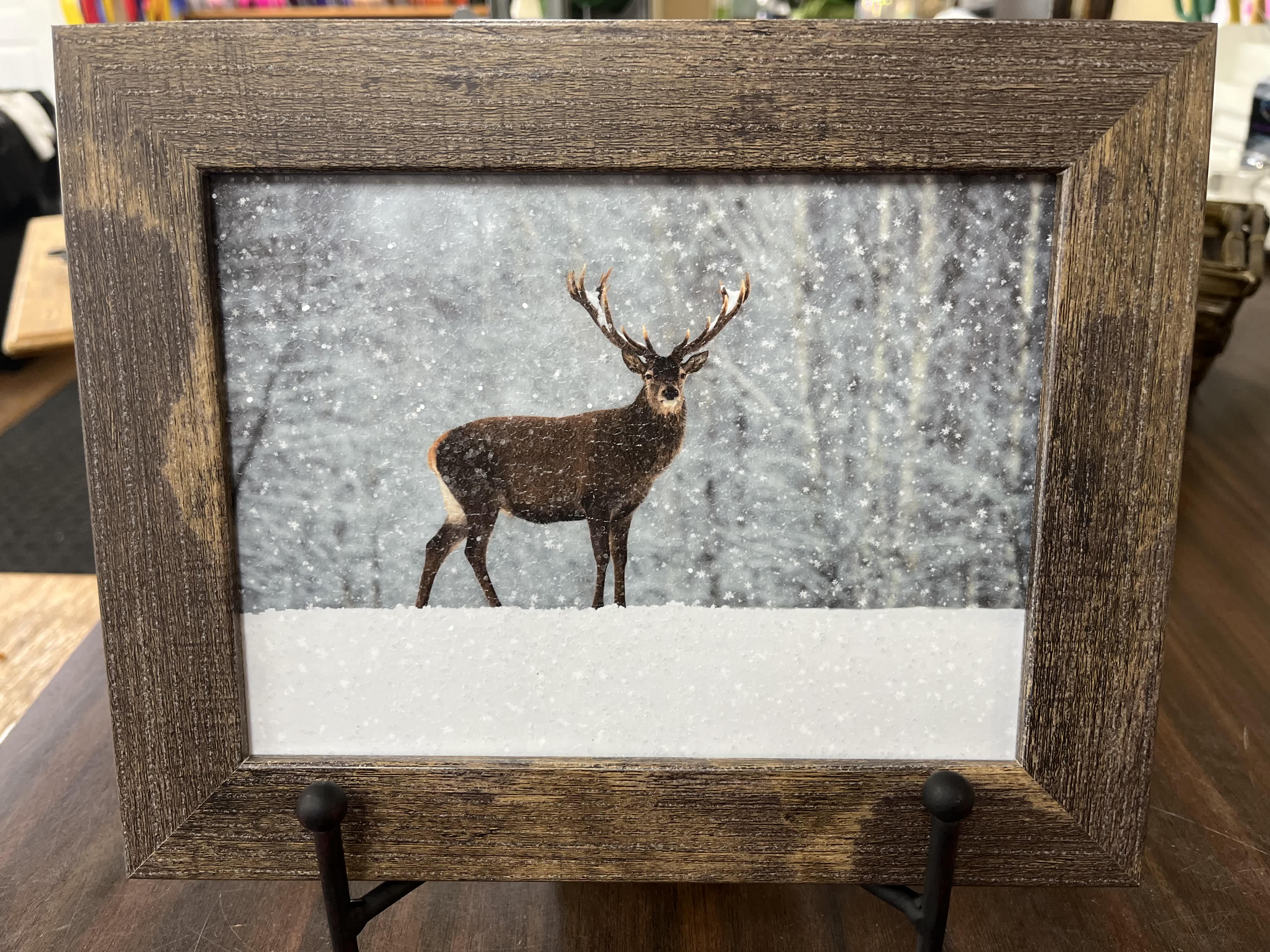 Framed winter scene of a deer standing in snow