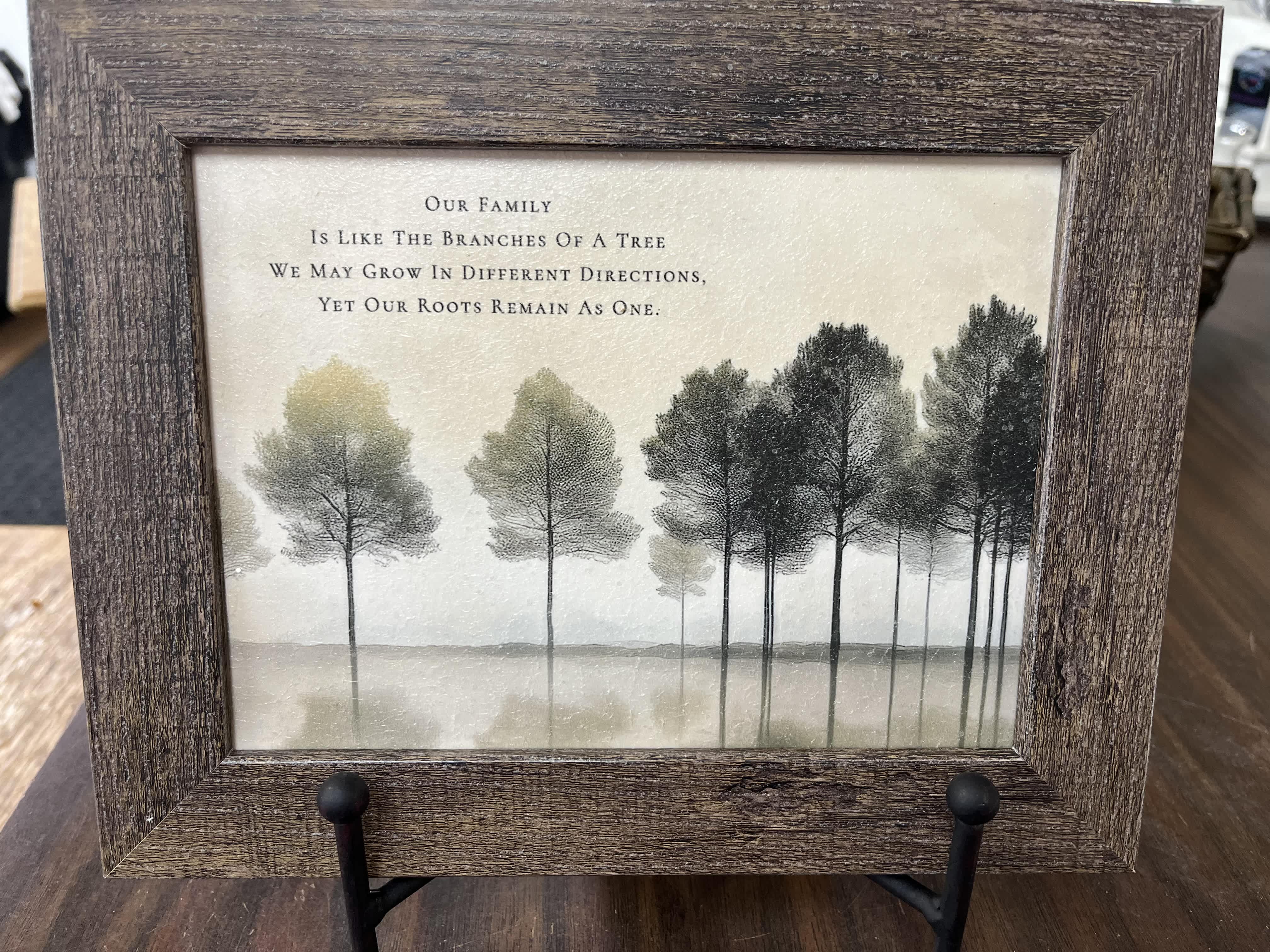 Framed tree artwork with a family quote on a stand