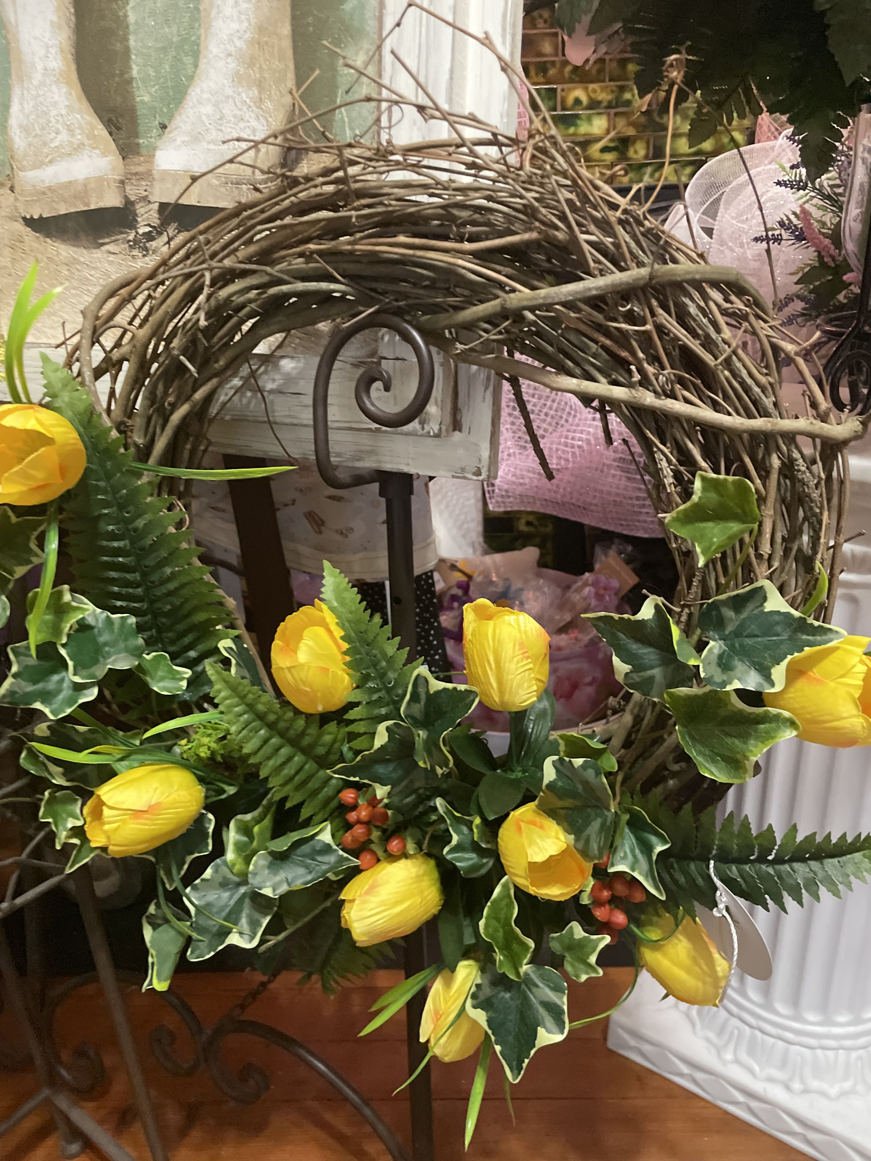Yellow tulips arranged with ivy in a twig wreath