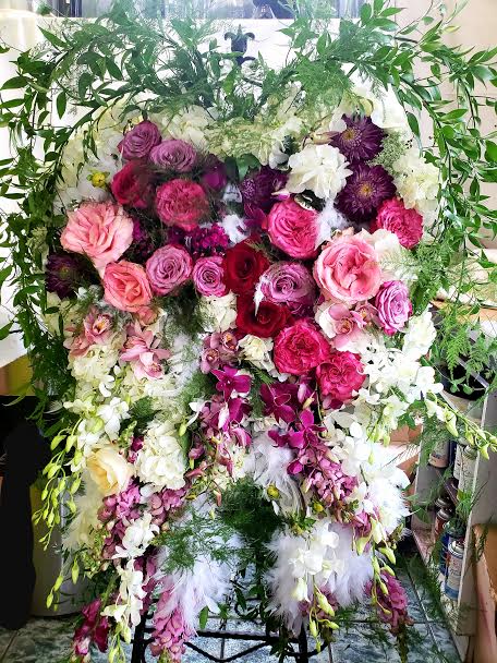 Large standing floral spray with pink, purple, and white flowers