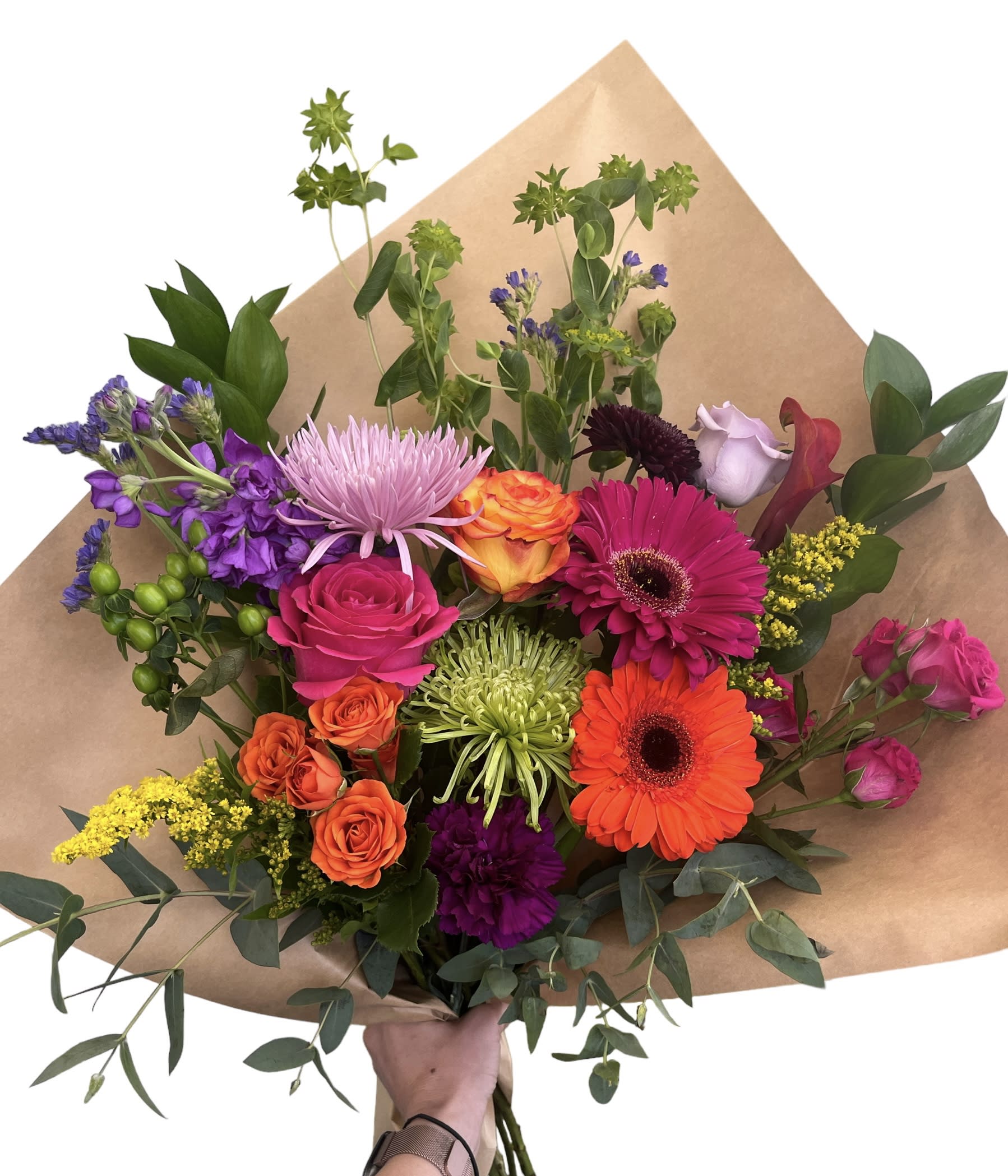 Colorful mixed bouquet with roses, gerberas, and purple blooms in brown paper