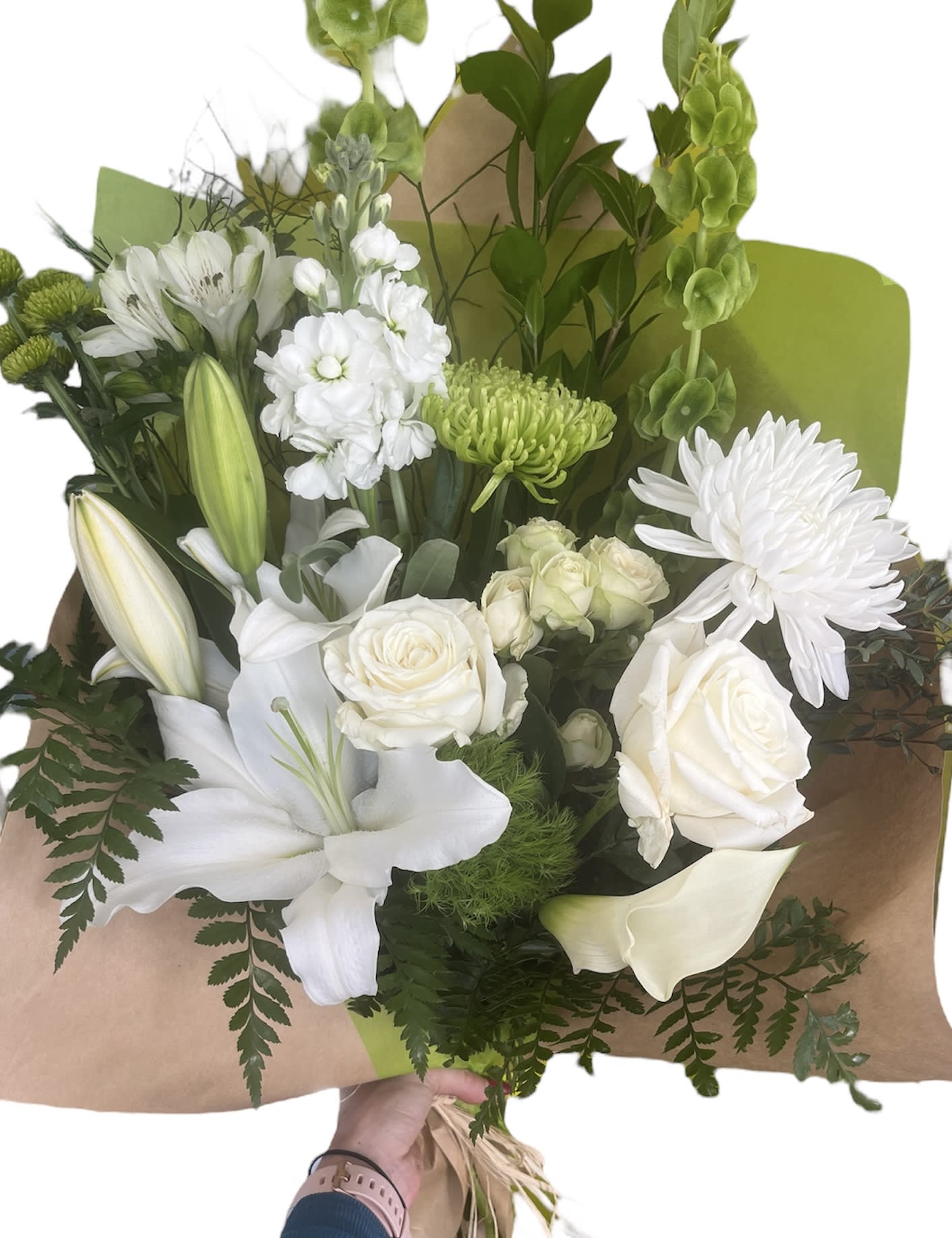 White bouquet with lilies, roses, and chrysanthemums wrapped in brown paper