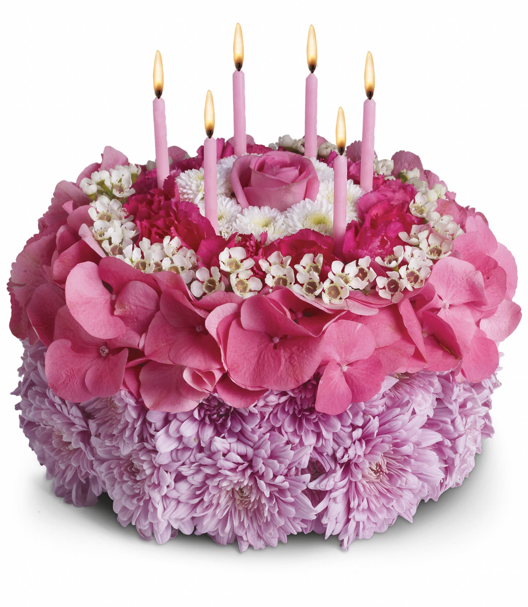 Pink floral cake with lit candles on top