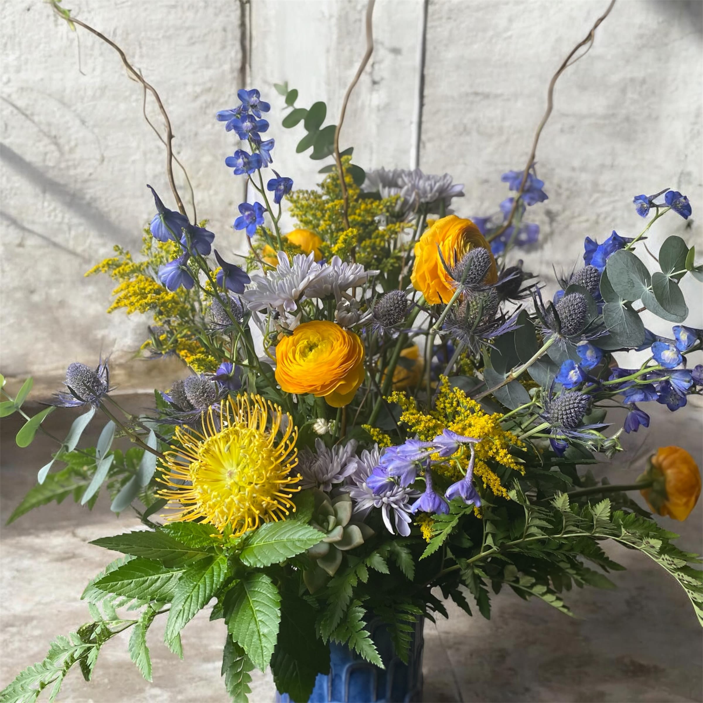 Playing the Blues  - Feeling a little blue lately, then we got you!  This stunning blue and yellow arrangement is perfect for any occasion, baby, birthday or just for fun!