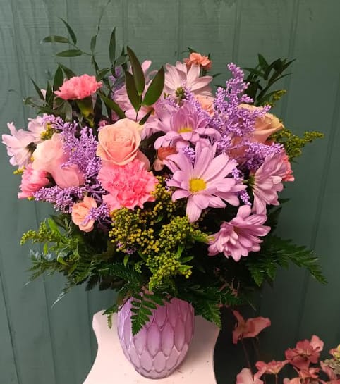 Pink and lavender mixed bouquet in a textured pink vase
