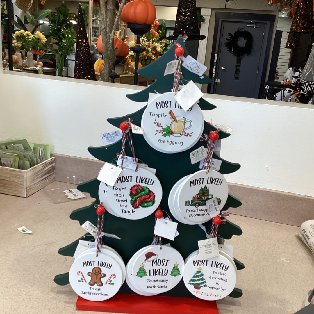 Christmas tree-shaped display with hanging round ornaments and tags
