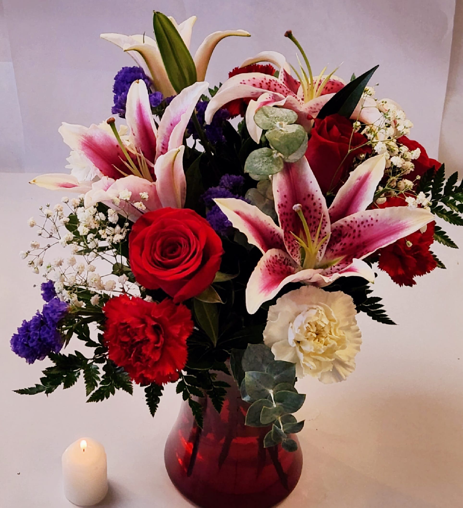 Pink and passionate  - Lovely lilies and red roses with accent flowers will sure to make them smile.  