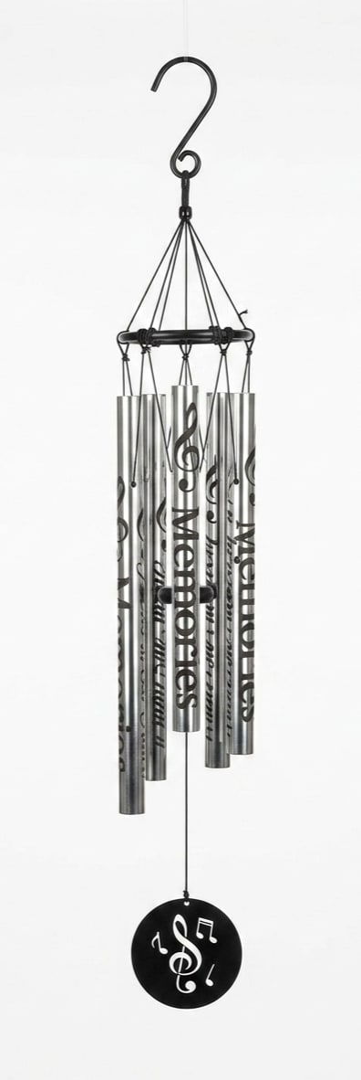 " Memories Forever in our Hearts" Wind Chime - A lyrical stainless steel wind chime engraved with the words "Memories" and "Forever in Our Hearts" offers a calm, reflective presence for sympathy and funeral settings or as a year-round memorial keepsake. The tall mixed-color/monochrome palette-silver tubes with flowing black script and musical notes-creates a soothing visual and audible tribute that helps the person you're honoring feel remembered and cherished.  Hand-tuned metal tubes hang from a black circular frame and finish with a round black windcatcher disc pierced with musical symbols and a treble clef, reinforcing the musical theme. The piece measures 37" long from the top of the gathering ring to the bottom of the windcatcher (overall 5" x 37" height) and includes a 2" hook for easy hanging. A matching green metal easel stand with a triangular base is available for presentation if you prefer a freestanding display; choose the deluxe option to include the stand.
