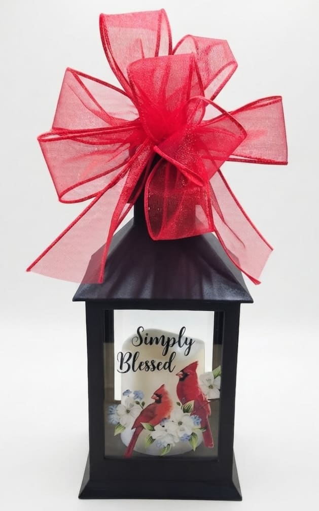 Black lantern with a red bow and a "Simply Blessed" card inside