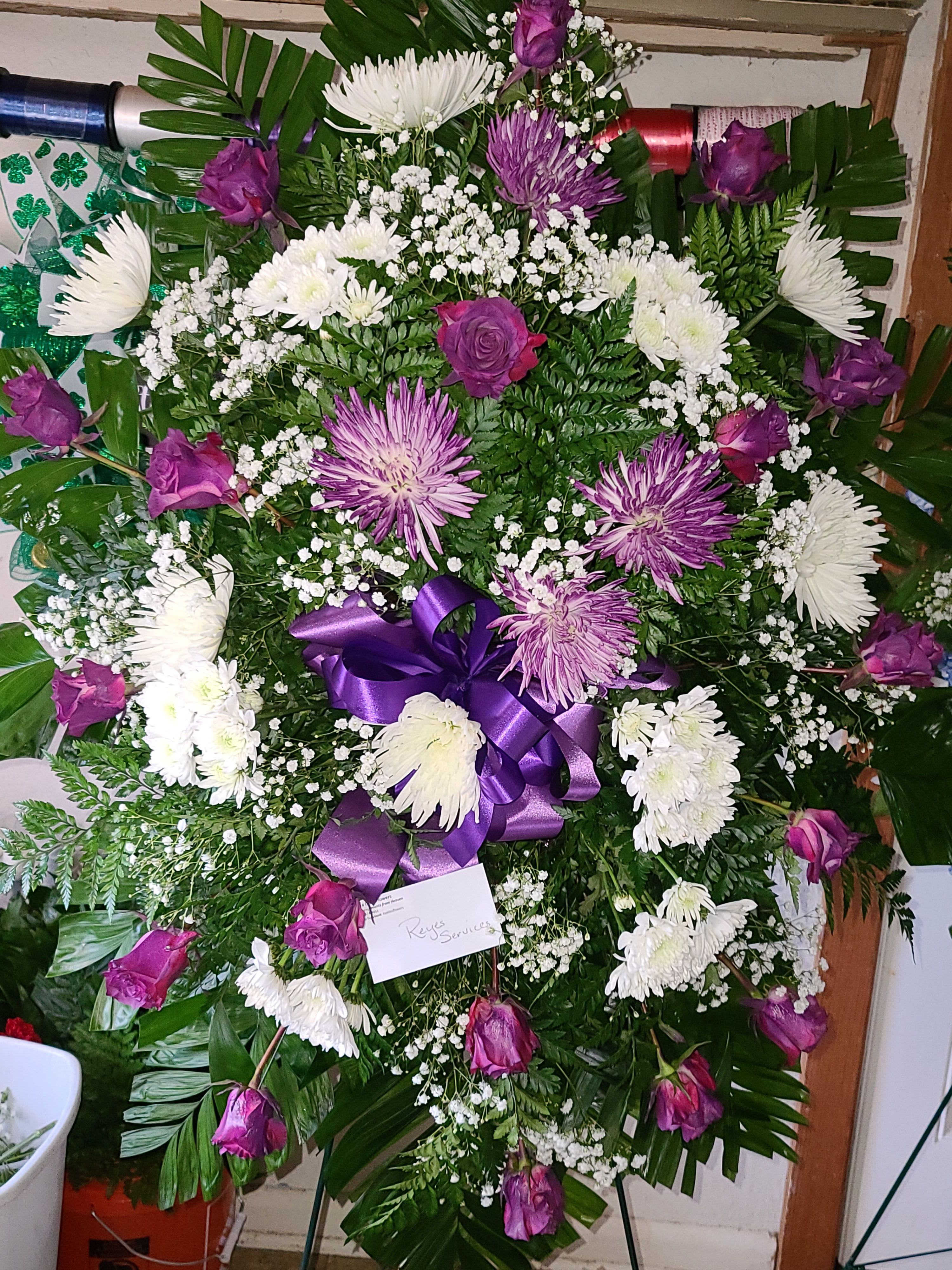 Purple and white funeral wreath with roses and chrysanthemums