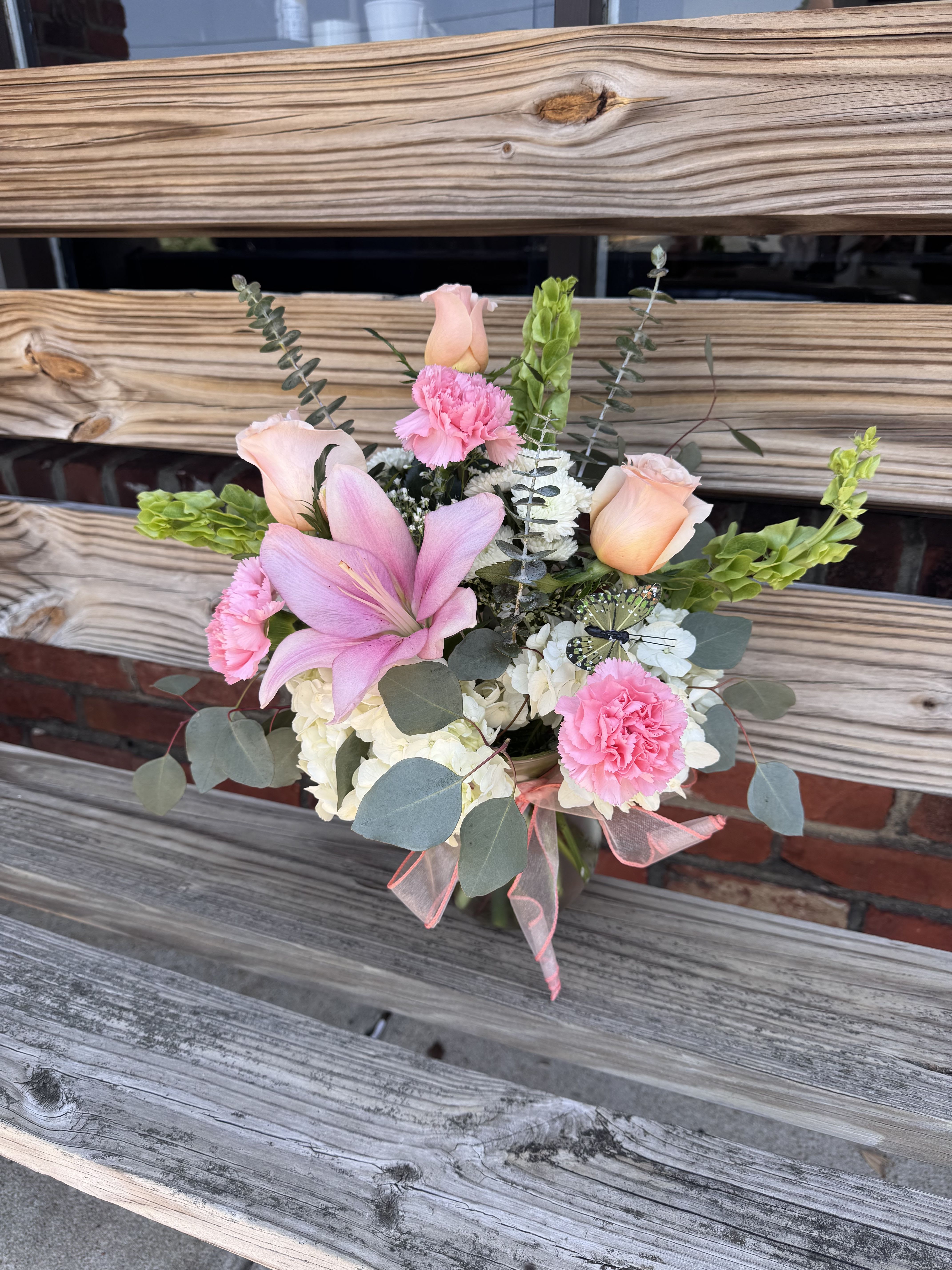 Tiny Dancer - Soft pink, green and white arrangement featuring hydrangea, roses, bells of Ireland, lily and eucalyptus.