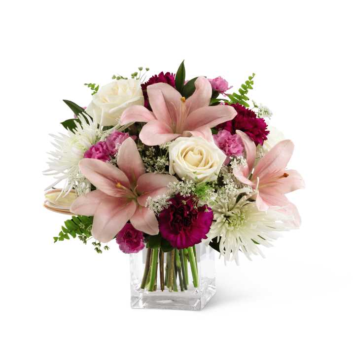 The FTD Shared Memories Bouquet - The FTD Shared Memories Bouquet is a sweet and blushing remembrance of the life and love of the deceased. White roses, pink Asiatic lilies, burgundy carnations, fuchsia mini carnations, white spider chrysanthemums, Queen Anne's Lace and a variety of lush greens are gracefully arranged in a clear glass cube to create an elegant and sophisticated way to pay tribute to a loved one you will never forget.