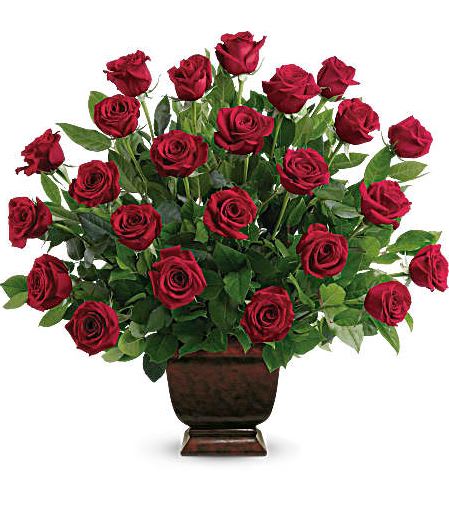 Red roses arranged in a dark urn vase
