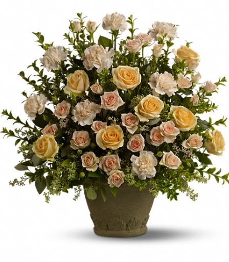 Teleflora's Rose Remembrance - To create a truly stunning tribute, choose a magnificent, fragrant display of peach roses, spray roses and carnations - accented with greenery, and displayed in a classic Grecian Garden urn. A gracious mark of respect for a life well-lived. A mix of fresh peach flowers such as roses, spray roses and carnations - accented with greenery - is delivered in a Grecian Garden urn. Approximately 22 3/4" W x 22 1/4" H 