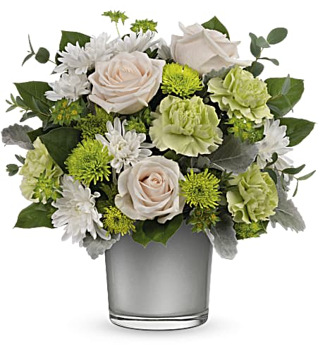 White and green floral arrangement in a clear glass vase