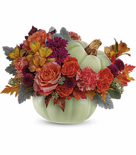 Pumpkin-shaped vase with orange and purple flowers