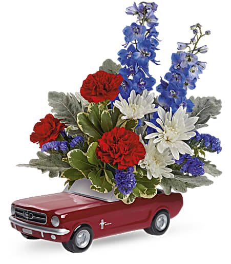 Floral arrangement in a red car-shaped container