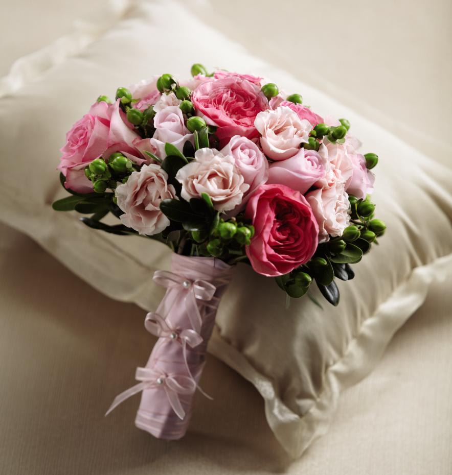 FTD Pink Profusion Bouquet - The FTDÂ® Pink Profusionâ¢ Bouquet bursts with every shade of blushing  beauty. Pink roses and spray roses are brought together with bi-colored  pink roses, fuchsia garden roses, green hypericum berries and lush  greens to create a gorgeous bouquet. Tied together with designer pink  satin ribbon accented with pearl pins, this bouquet makes a gorgeous  statement as it is carried down the aisle. Approx. 10âH x 10âW. 