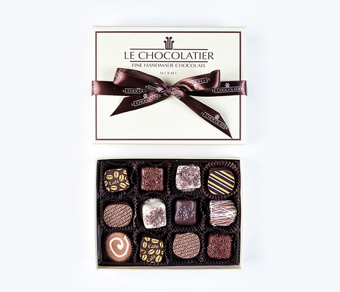 Box of assorted chocolates with a ribbon-tied lid