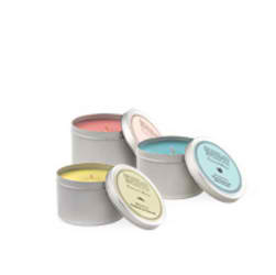 Three scented candles in gray tins with pastel lids