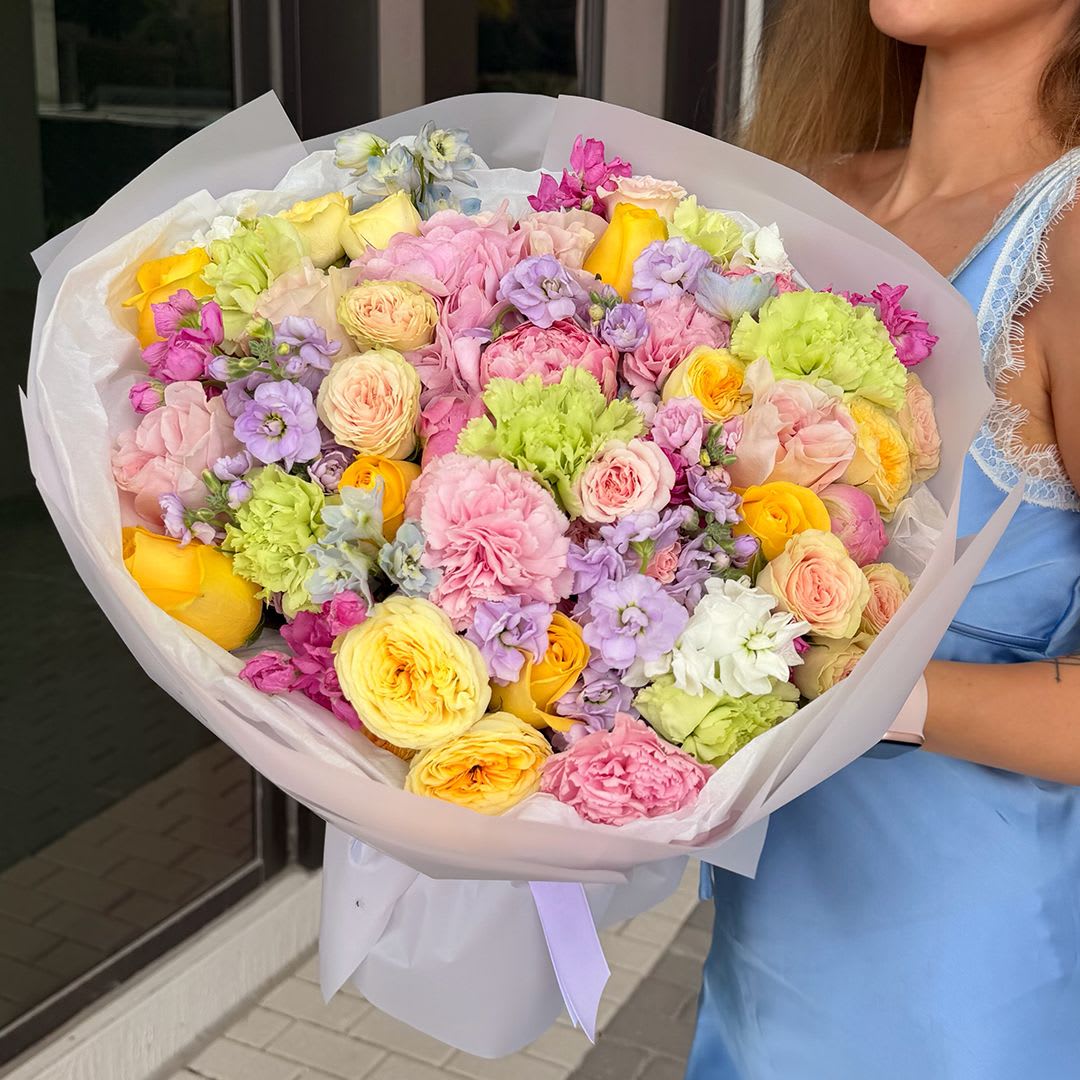 Pastel Garden Symphony - A lush, romantic bouquet designed in soft pastel tones, blending the charm of an English garden with modern luxury floristry. This arrangement features an elegant mix of blush pink and lavender blooms accented with buttery yellow garden roses for a fresh, cheerful touch.
