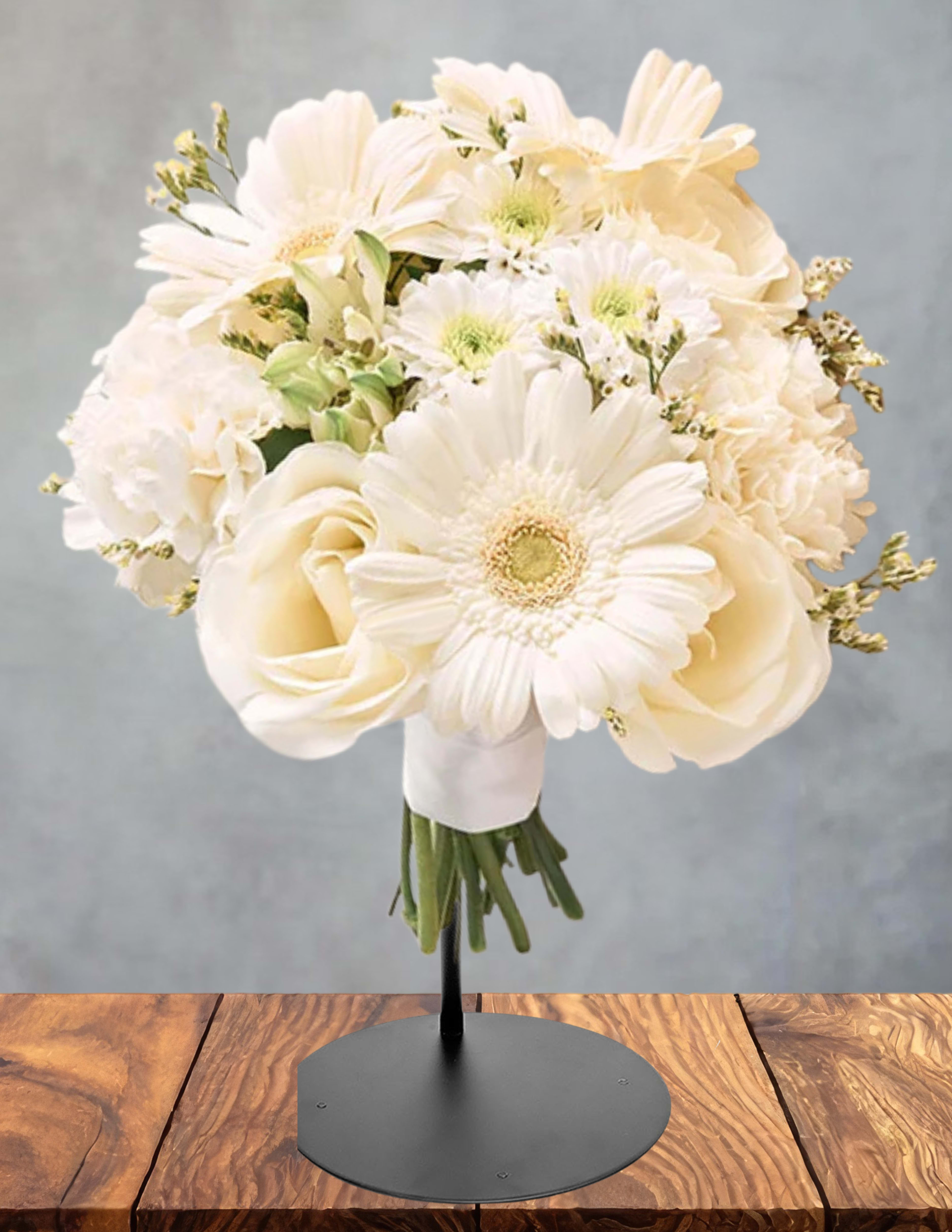 Cream bouquet of gerbera daisies and roses on a stand