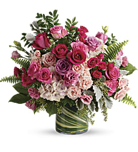 Pink and white rose bouquet in a glass vase