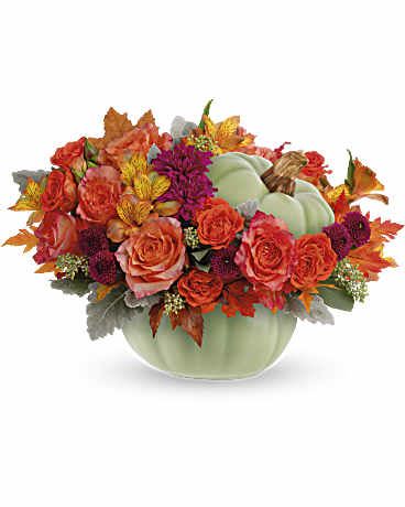 Sage Harvest Bouquet -  Bring autumn's charm to your table with Teleflora's Sage Harvest Bouquet, a delightful centerpiece adorned with rustic elegance. Nestled in a timeless hand-painted ceramic pumpkin, its exquisite details and warm, earthy hues create a captivating focal point.      This arrangement features orange roses, spray orange roses, orange alstroemeria, orange carnations, purple button spray chrysanthemums, purple cushion spray chrysanthemums, dusty miller, seeded eucalyptus, and is delivered in Teleflora's Sage Harvest Pumpkin. The perfect blend of autumn hues and floral elegance for any occasion.