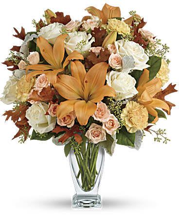 Seasonal Sophistication Bouquet -  Capture the natural beauty of autumn with this stunning arrangement of lilies and roses in an elegant glass vase, sure to brighten any fall day.      This beautiful arrangement features white and peach roses, peach asiatic lilies and peach carnations and is finished with dusty miller, seeded eucalyptus, brown oak leaves and lemon leaf.     Delivered in Teleflora's Couture vase.