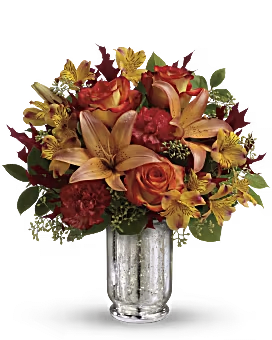 Teleflora's Fall Blush Bouquet - Stunning orange bi-color roses are arranged with orange asiatic lilies, yellow alstroemeria, dark orange carnations, seeded eucalyptus, lemon leaf and oak leaves. 