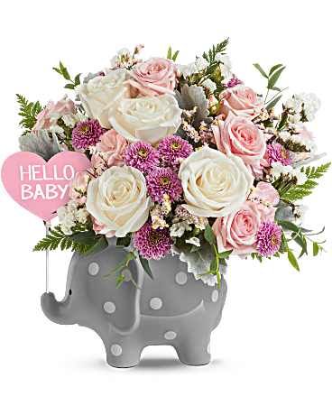 Teleflora's Dreamy Delight Bouquet - Pink  - Teleflora's Dreamy Delight Bouquet - Pink features crème roses, pink spray roses, pink miniature carnations, lavender button spray chrysanthemums, white sinuata statice, pink limonium, dusty miller, parvifolia eucalyptus, and leatherleaf fern. Arranged in Teleflora's Hello Baby Elephant Keepsake. 