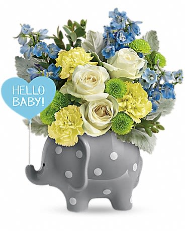 Teleflora's Hello Sweet Baby - Blue - This adorable gift features white roses, yellow carnations, light blue delphinium, green button spray chrysanthemums, parvifolia eucalyptus, and dusty miller. Delivered in a Hello Baby Elephant. 