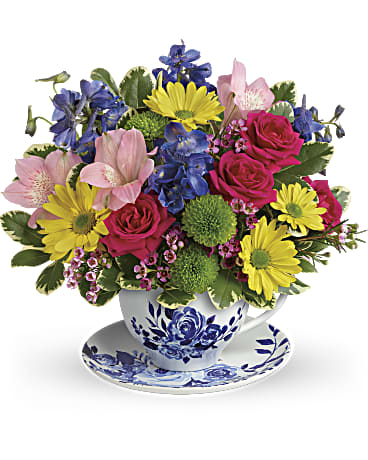 Mixed bouquet in a blue-and-white teacup and saucer