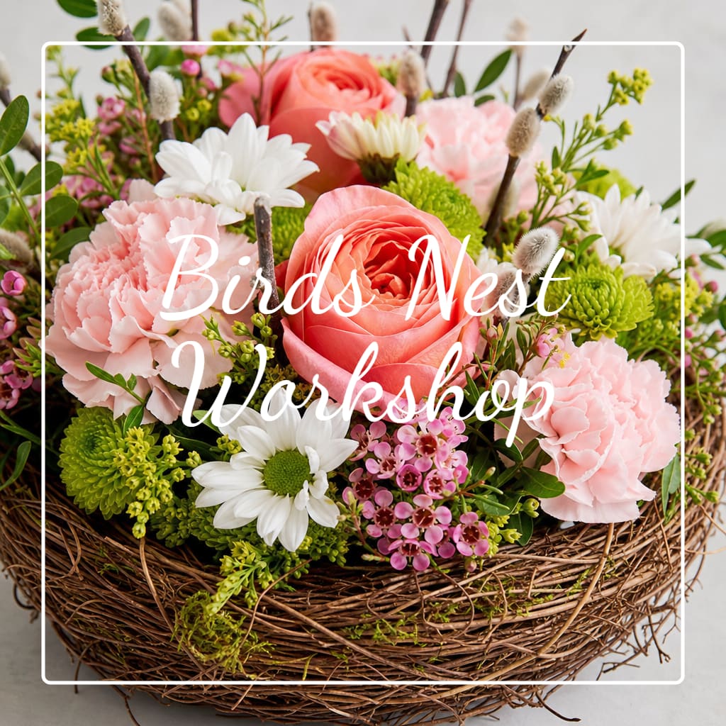 Basket arrangement of pink and white flowers with green accents